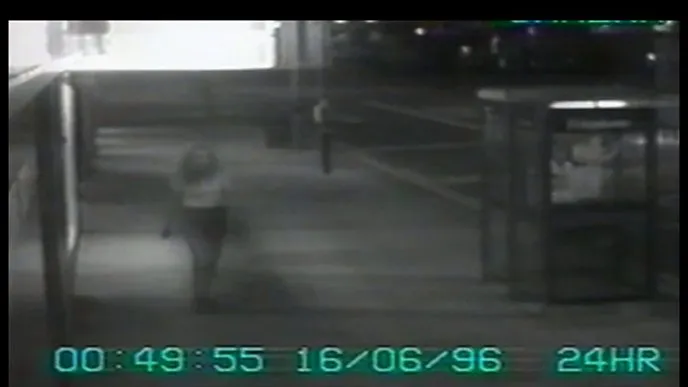Black-and-white CCTV frame released during the Janet Murgatroyd murder appeal, showing a distant figure in Preston